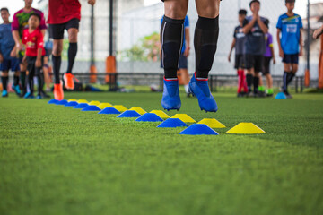 Soccer ball tactics on grass field with barrier for training children jump skill