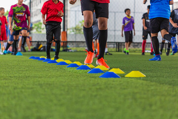 Soccer ball tactics on grass field with barrier for training children jump skill