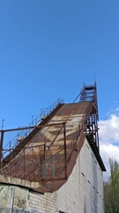 old abandoned rusty springboard against the blue sky 
