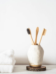 Set of wooden bamboo toothbrushes in ceramic glass