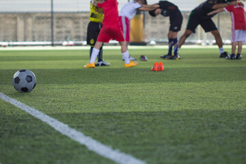 Soccer ball tactics on grass field with children warm up