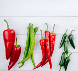 top view of green and red hot chili peppers isolated on white background