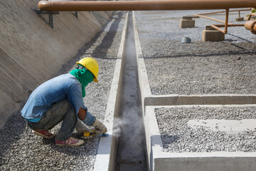 Builder worker with grinder machine polished finishing concrete drain water