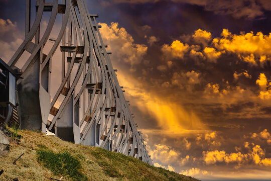 Workers are repairing a noise barrier by a road. Renovation work in a residential area.
