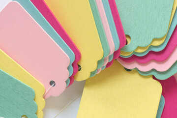 colorful background composed of wooden pastel-colored chalkboard tags layered over one another on a...