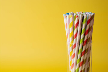 Biodegradable paper eco straws. Zero waste straws on yellow background. Copy space.