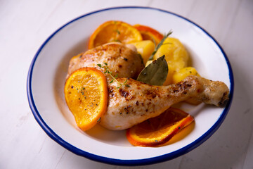 Chicken cooked with potatoes and orange sauce.