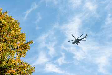 Combat helicopter flying across the sky
