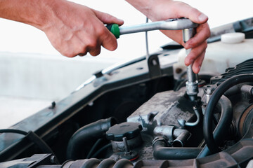 Fototapeta premium Car repair. Auto mechanic working on car engine in mechanics garage. Repair service. close-up shot