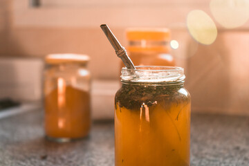 Close-up of a healthy tea with herbs and honey.