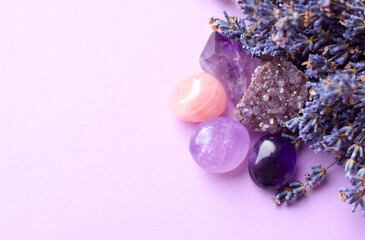 Beautiful amethyst crystals and round rose quartz stone with dry lavender bouquet. Magic amulets. Copy space