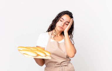hispanic pretty chef woman feeling bored, frustrated and sleepy after a tiresome and holding a...