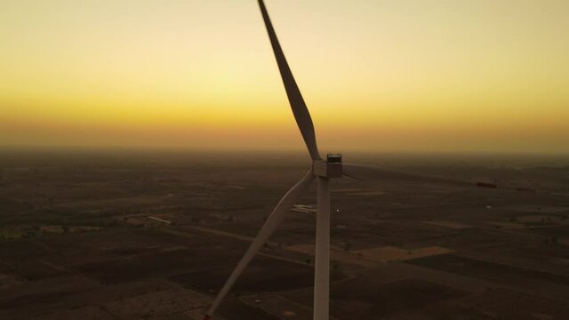 Aerial view over the farm landscape and wind turbines generating clean renewable energy. Renewable energy production for the green ecological world.