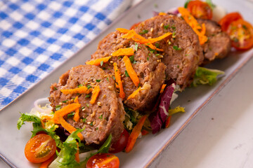 Meat roll with salad. Cooked in the oven. Traditional northern Spanish dish.