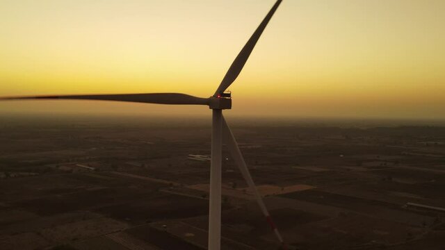 Aerial view over the farm landscape and wind turbines generating clean renewable energy. Renewable energy production for the green ecological world.
