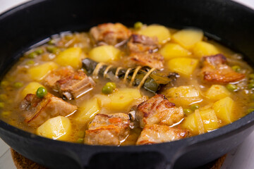 Pork stew with peas and potatoes. Traditional tapa from the north of Spain.