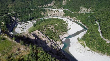 Fototapeta na wymiar Europe, Italy, Val Trebbia, Brugnello is an ancient historical village above the mountain overlooking the incredible river that reaches Bobbio - drone view of San Salvatore , the bends of the river