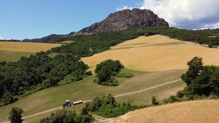 Fototapeta na wymiar Europe, Italy , Travo - Drone aerial view of Pietra Parcellara , a mountain of volcanic origin in the Ligurian Apennines located in the Trebbia valley - drone flight over the mount and wood 