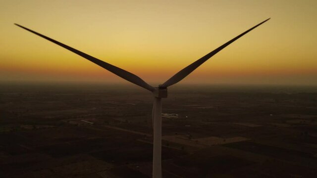 Aerial view over the farm landscape and wind turbines generating clean renewable energy. Renewable energy production for the green ecological world.