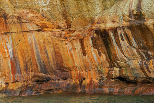 Abstract landscape of mineral stained cliff along the eroded sandstone shoreline of Lake Superior, Pictured Rocks National Lakeshore, Michigan’s Upper Peninsula, USA