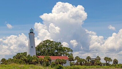 Fototapeta na wymiar Tropical lighthouse with cumulous clouds