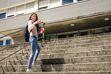 Student girl at college calling friends to enter with her