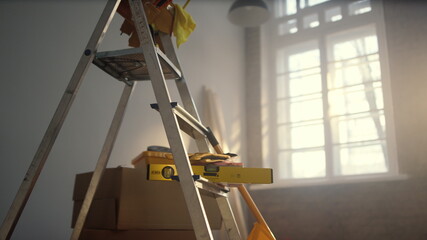 Closeup ladder and tools in new house. House renovation tools in apartment.
