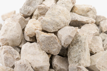 Gray small rocks ground texture isolated on white background. Small road stone.