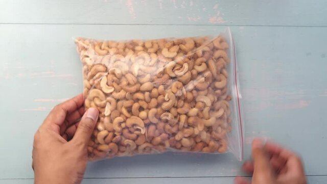 top view of cashew nuts in a plastic packer on table 