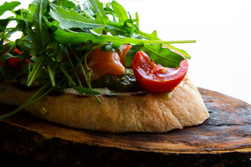 Italian tomato bruschetta with chopped vegetables, herbs and oil on grilled or toasted crusty ciabatta bread