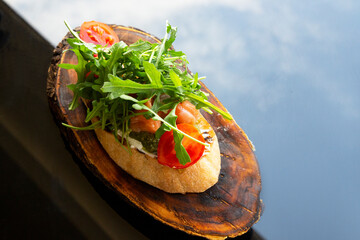 Italian tomato bruschetta with chopped vegetables, herbs and oil on grilled or toasted crusty...