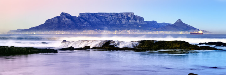 Fototapeta premium Twilight panoramic of Table Mountain in Cape Town as viewed from Bloubergstrand, South Africa.