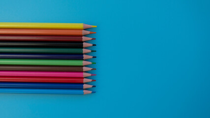Colored pencils on a blue background. Great For Your Back To School. Art Supplies Related Projects.
