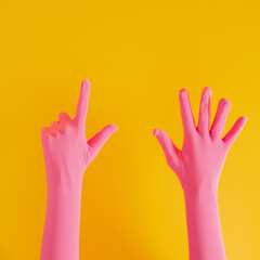 Obraz premium hands with pink glove and number seven on yellow sunny summer background. modern summer abstract art