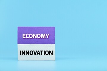 colored cubes with the words economy innovation. business concept