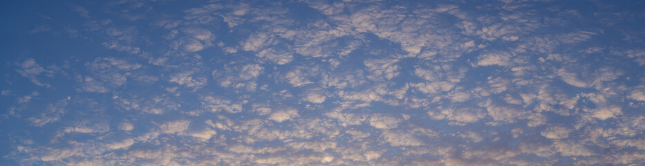 Naklejka na ściany i meble Cirrus cloudscape on blue sky. The evening sunset. Majestic Clouds.