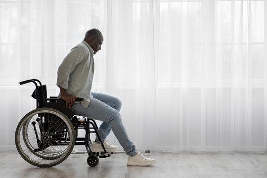 Concentrate tense mature african american man disabled stands up from wheelchair