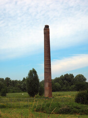 Chimney is all that left of an damaged stone factory, Bommelerwaard, Netherlands. On the chimney is...