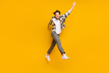 Fototapeta na wymiar Full size profile side photo of young man happy positive smile have fun jump go walk step isolated over yellow color background