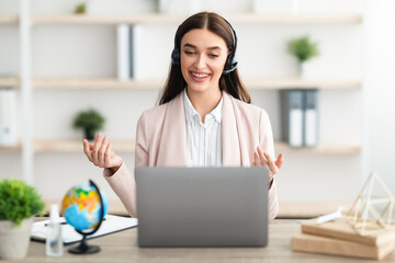 Cheerful Female Talking Via Video Call On Laptop In Office