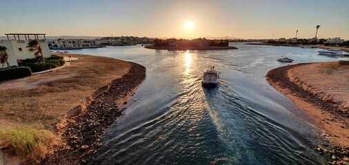 Sunset over El Gouna, Egypt. Boat going out from Abu Tig Marina.