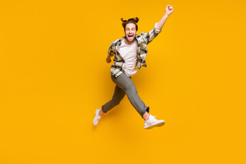 Fototapeta na wymiar Full body photo of energetic young happy man jump up run empty space smile isolated on yellow color background