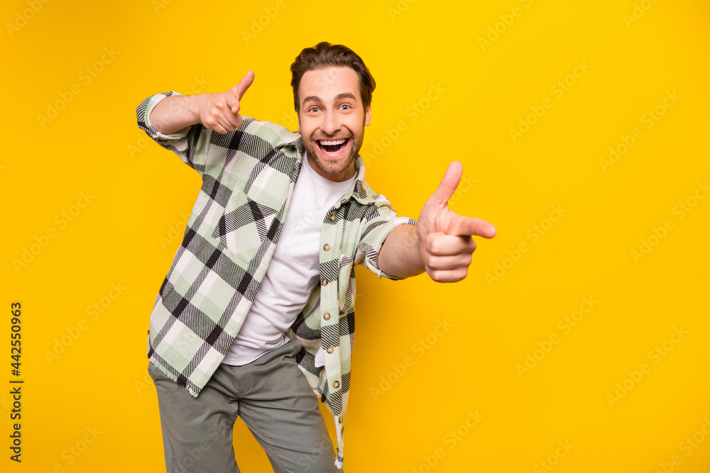 Sticker Photo of young excited handsome man happy positive smile point fingers you select choice isolated over yellow color background