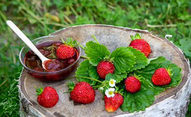 Strawberry jelly, jam on a wooden background, environmentally friendly product.