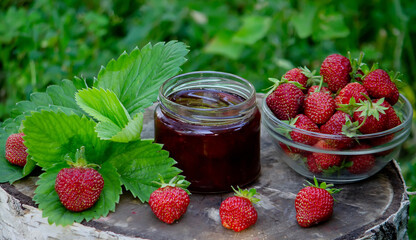 Strawberry jelly, jam on a wooden background, environmentally friendly product.