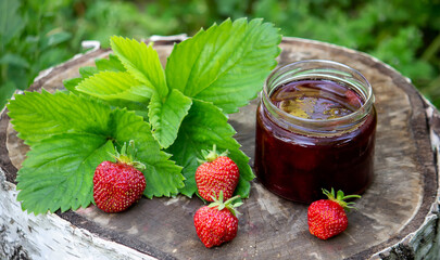 Strawberry jelly, jam on a wooden background, environmentally friendly product.
