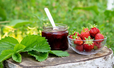 Strawberry jelly, jam on a wooden background, environmentally friendly product.