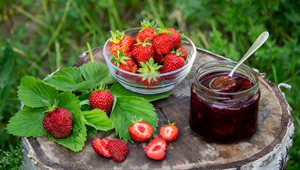 Strawberry jelly, jam on a wooden background, environmentally friendly product.