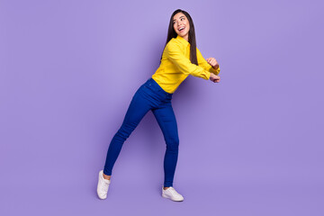 Fototapeta na wymiar Full length photo of charming funky young woman look empty space dance isolated on violet color background