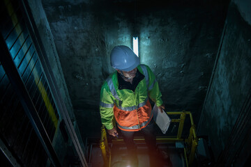 worker service check  elevator. service  engineer work in elevator shaft